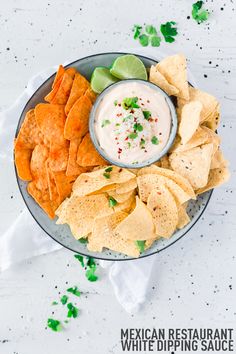 a plate with chips, guacamole and tortilla chips