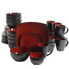 red and black dishes are stacked on top of each other, with cups in the middle