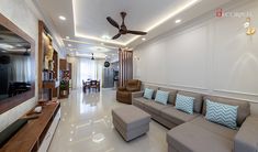 a living room filled with lots of furniture and a flat screen tv mounted to the wall