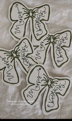 four tags with bows and names on them