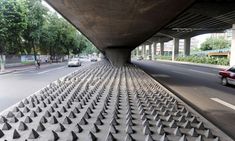 an article about the design and construction of a pedestrian bridge in mexico, with pictures of cars driving under it