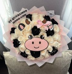 a bouquet of white and black roses with a cow face on it