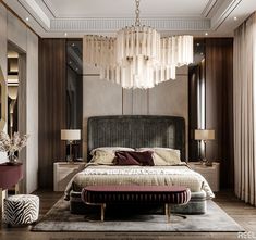 a bedroom with a large bed and chandelier hanging from the ceiling