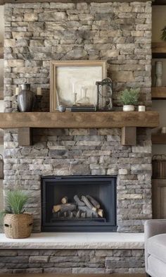 a living room with a stone fireplace and shelves