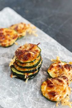 zucchini stacked on top of each other with cheese and seasoning next to it