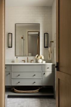 a bathroom with two sinks and a large mirror