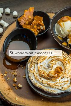 there are four different desserts in bowls on the wooden table with marshmallows