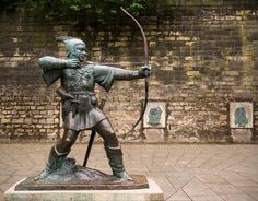 a statue of a man with a bow and arrow