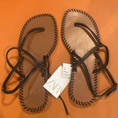 New With Tags Zara Leather Sandals Size 7.5 Usa/38 European Chic Brown T-strap Sandals With Flat Heel, Chic Brown Flat Heel T-strap Sandals, Chic Brown Flat T-strap Sandals, Chic Brown T-strap Sandals For Vacation, Chic Brown Toe Post Sandals, Zara Black Sandals For Vacation, Zara Flat Leather Sandals, Zara Leather Sandals With Single Toe Strap, Zara Brown Leather Sandals