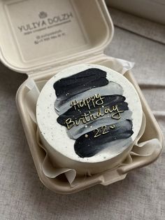 a birthday cake in a box with writing on it