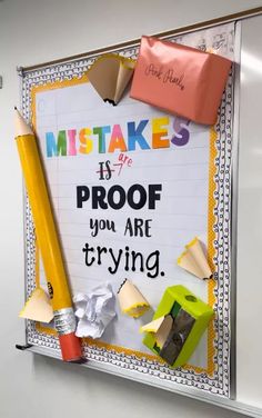 a bulletin board that has been decorated with school supplies on it and the words, mistakes is proof you are trying