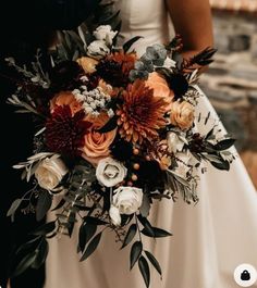 a bride and groom standing next to each other holding a wedding bouquet in their hands