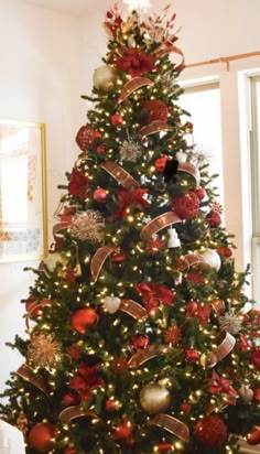 a decorated christmas tree with red and gold ornaments