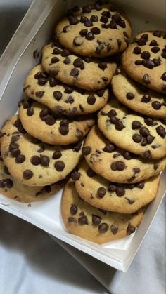 a box filled with chocolate chip cookies on top of a table