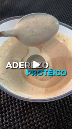 a spoon is being used to dip something in a bowl with the word aderbo proteicoo on it