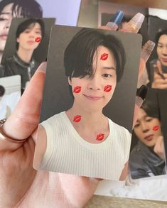 a person holding up a card with lipstick on it