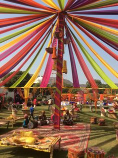 an outdoor event with colorful decorations and tables