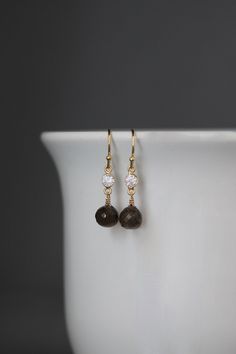 "Sweet rich micro faceted Brown Smokey Quartz onion briolette stones are wire wrapped with 14k gold filled wire onto 18k gold vermeil links with sparkling cubic zirconia bezel set stones.  These dangle from 18k gold vermeil balled earwires. Lovely dainty earrings with lots of sparkle! Cubic Zirconia links: 5x10mm Smokey Quartz stones: 8mm Total length of earrings: 1 1/4\" As the owner, maker, designer, and curator of this shop, I take great pride in providing you with jewelry that you will love Elegant Brown Brass Earrings, Elegant Brown Crystal Earrings Gift, Brown Adjustable Earrings With Natural Stones, Brown Brass Drop Earrings, Brown Gemstone Drop Earrings, Brown Gemstone, Zirconia Earrings, Cubic Zirconia Earrings, Wire Wrapped Earrings