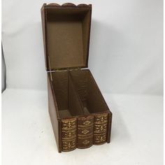 an open book box with three books inside