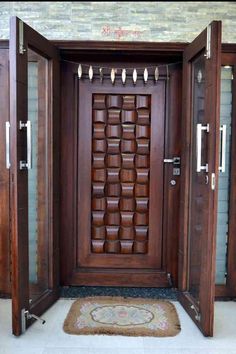 an open wooden door with metal handles