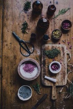 an overhead view of spices and herbs on a cutting board