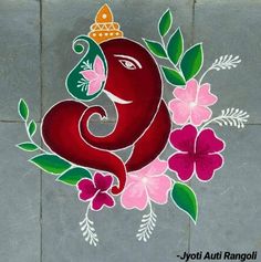 an elephant is painted on the ground with flowers and leaves around its neck, as if it's for ganeshi