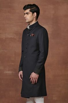 Black achkan crafted from fine pinstriped black wool textured fabric with contrast fabric and stitch lines cuff details. - Aza Fashions Black Sherwani For Winter, Black Semi-formal Kurta For Winter, Black Semi-formal Sherwani For Winter, Semi-formal Black Sherwani For Winter, Black Semi-formal Winter Kurta, Black Semi-formal Winter Sherwani, Semi-formal Black Winter Sherwani, Traditional Black Formal Outerwear, Fitted Black Kurta With Stand Collar