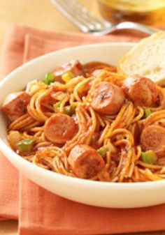 a white bowl filled with spaghetti and sausage