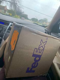 a fedex box sitting in the passenger seat of a car