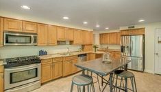 a kitchen with stainless steel appliances and wooden cabinets