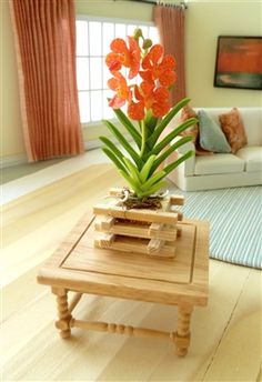 a living room filled with furniture and a flower pot on top of a coffee table