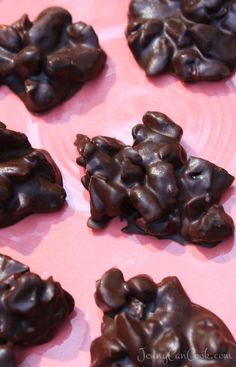 chocolate candies are arranged on a pink plate