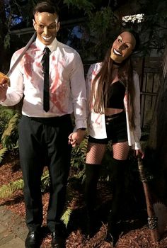 two people dressed up as zombies and one is holding a knife