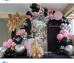 a black and silver balloon arch with balloons