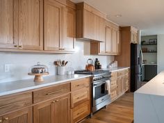 a kitchen with wooden cabinets and white counter tops