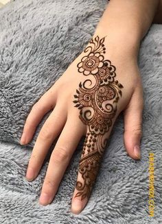 the hand is decorated with henna designs