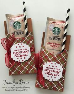 two starbucks bags with tags attached to them