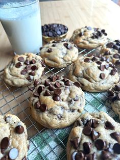 chocolate chip cookies cooling on a rack next to a glass of milk