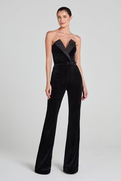 Vivianne Black Jumpsuit Women's Clothing > Jumpsuits. DESCRIPTION &  FEATURES    VIVIANNE is a tuxedo-inspired jumpsuit, crafted from exclusively designed black velvet, with a deep V-neckline. Featuring a structured lapel over the bust, a corseted bodice, our signature fit and flare pant, silhouette-enhancing seam detailing, and functional pockets. Finished with a concealed zip closure and detachable black velvet belt.     Pair it with the      HETTIE Bodysuit    to complete the look.    - Black Nadine Merabi, Structured Corset, Womens Black Jumpsuit, Velvet Belt, Black Velvet Fabric, Corset Boning, Pajama Suit, Flare Pant, Flare Trousers