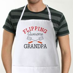 a man wearing an apron with the words flipping awesome grandpa written in red on it