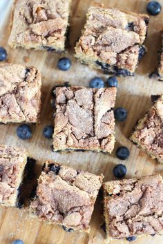 blueberry crumb bars are arranged on a cutting board