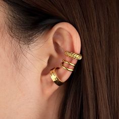 Take your style game to the next level with these fun Mini Croissant Ear Cuffs! Whether you use 'em to make a statement or just add a cheeky accent to your outfit, these stylish cuffs are sure to be a show-stopper. No need to knead dough, just slip 'em on and be a snack-happy fashionista! Material: 18k gold plated on stainless steel Chic Gold Single Ear Cuff, Trendy Clip-on Ear Cuff As Gift, Trendy Clip-on Ear Cuff For Gift, Modern Gold-plated Ear Cuff, Gold Minimalist Tarnish-resistant Ear Cuff, Minimalist Hypoallergenic Gold-plated Ear Cuff, Adjustable Gold Clip-on Ear Cuff, Mini Croissant, Mini Croissants