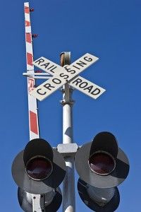 two traffic lights are on top of a railroad crossing sign