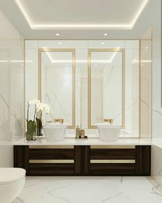 a large bathroom with two sinks and mirrors