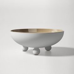 a white and gold bowl sitting on top of a table