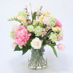 a vase filled with pink and white flowers