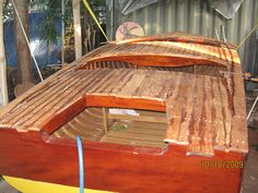 a wooden boat being built in a yard