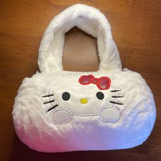 Hello Kitty Plush Handbag Or Crossbody. Color Is White Nwot Has Adjustable Strap. Zipper Closure. Measurements Are Pictured And Approximate. Overall From Top To Bottom, Lying Flat Is Approximately 10 1/2”, Height Of The Bag Is Approximately 5”, Length 8 1/2 And 4” Deep. Has Hello Kitty Character Face On The Front And The Words , Hello Kitty Embroidered On The Back. If You Have Any Questions Please Message Me. Playful White Bags With Hello Kitty Print, White Playful Hello Kitty Print Bags, Playful White Hello Kitty Print Bag, Casual White Bag For Playtime, Kawaii Hello Kitty Bag, Character Face, Hello Kitty Characters, Kitty Plush, Plush Backpack