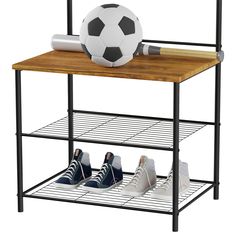 a soccer ball sitting on top of a wooden shelf next to two pairs of shoes