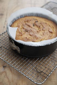 a cake in a pan on a cooling rack